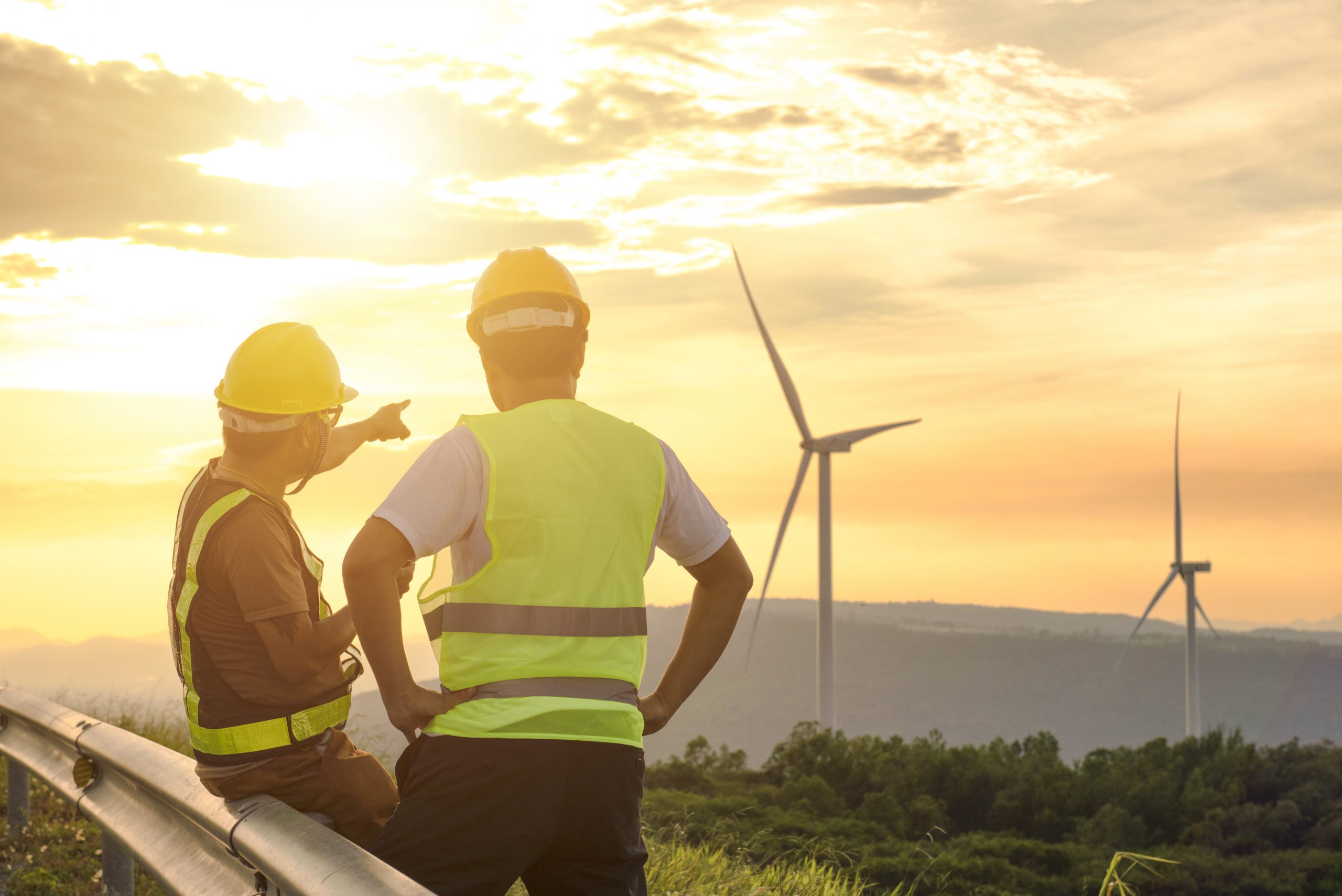 Two engineers discussed the plan for the maintenance of wind tur