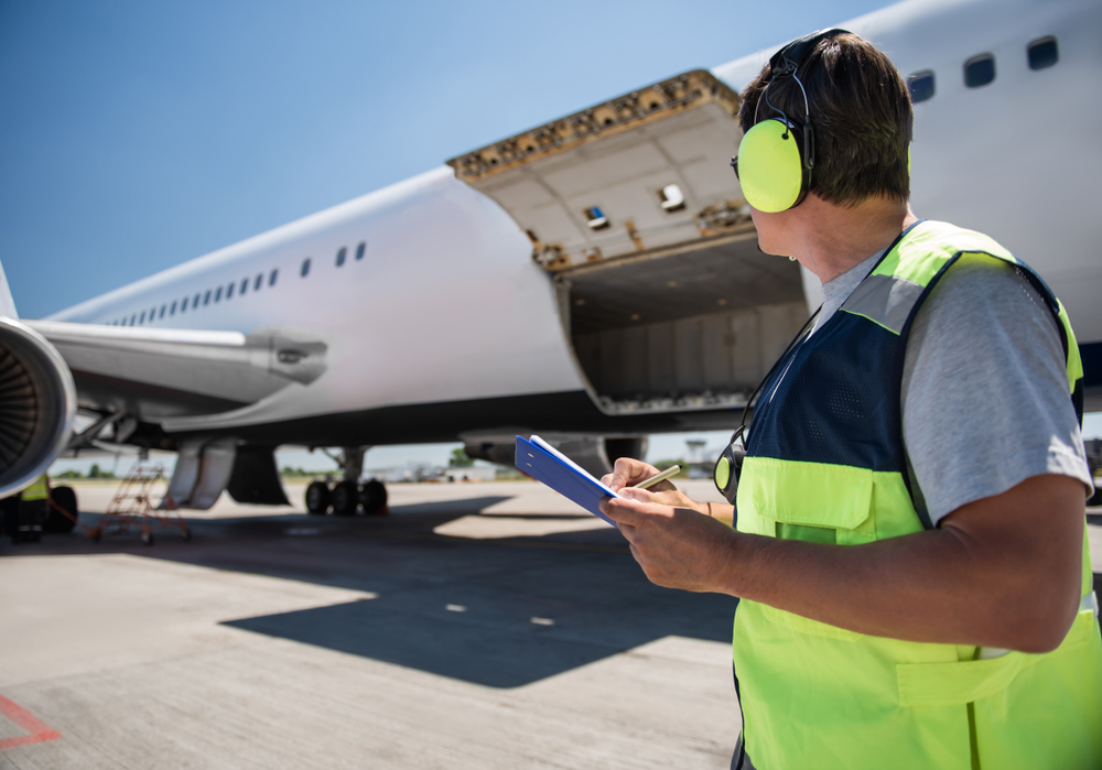 Aircraft,Ground,Handling.,Man,In,Headphones,Observing,Airplane,With,Open